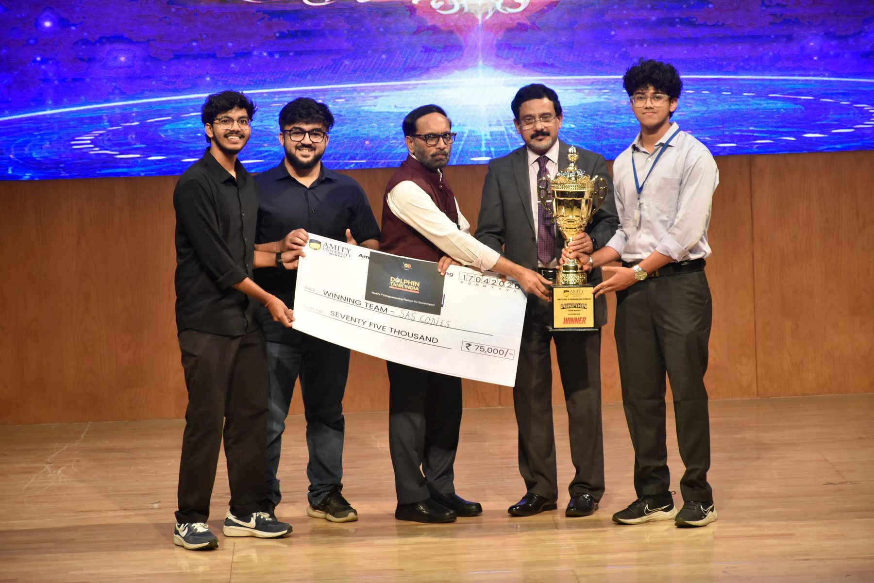 Team SAS Codies on stage receiving the Nirman 2026 winner's trophy and the ₹75,000 prize cheque